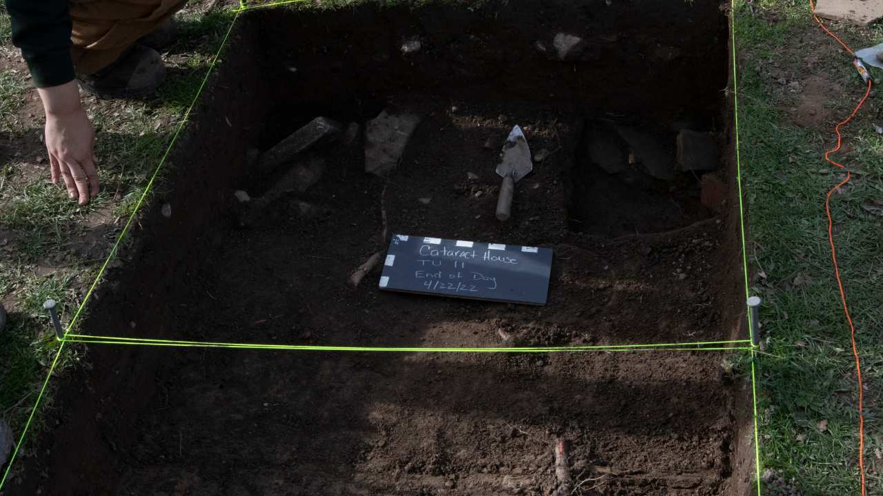 a hole in the ground with a trowel